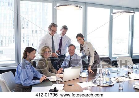 Business people smiling in meeting View Large Photo Image Stock Photograph - Business people smiling in meeting. Fotosearch