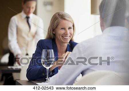 Business people smiling in restaurant View Large Photo Image Stock Image - Business people smiling in restaurant. Fotosearch