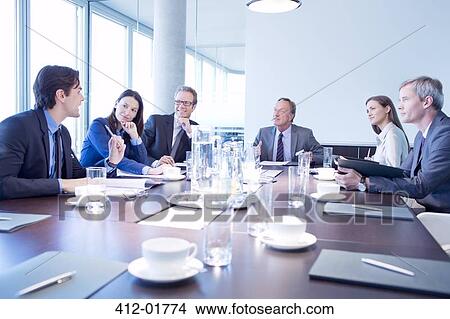 Picture - Business people talking in meeting. Fotosearch