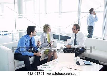 Business people talking in office lobby View Large Photo Image Stock Image - Business people talking in office lobby. Fotosearch