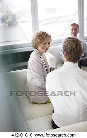 Business people talking in office lobby View Large Photo Image Stock Image - Business people talking in office lobby. Fotosearch