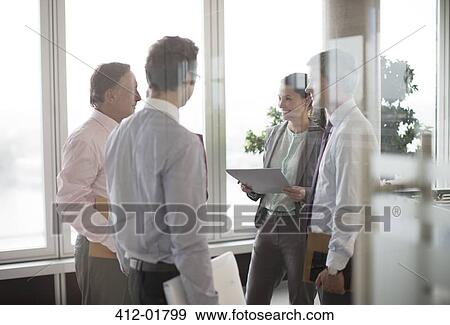 Business people talking in office lobby View Large Photo Image Stock Photo - Business people talking in office lobby. Fotosearch