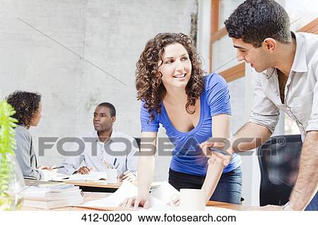 Stock Image - Business people talking in office. Fotosearch