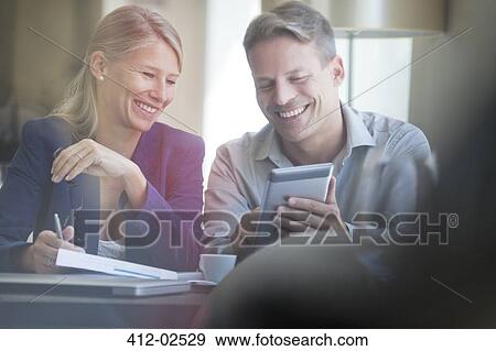 Stock Photo - Business people using digital tablet. Fotosearch