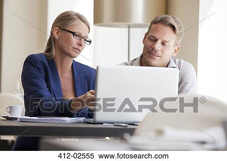 Business people working on laptop View Large Photo Image Stock Photography - Business people working on laptop. Fotosearch