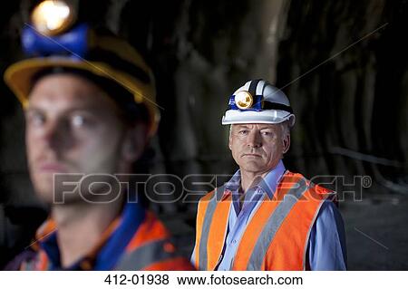 Businessman and worker standing in tunnel View Large Photo Image Stock Photo - Businessman and worker standing in tunnel. Fotosearch