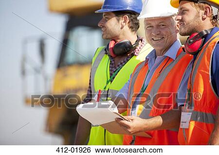 Businessman and workers talking on site View Large Photo Image Stock Photograph - Businessman and workers talking on site. Fotosearch