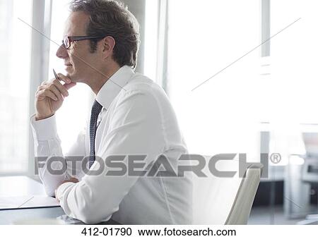 Businessman thinking at desk View Large Photo Image Stock Image - Businessman thinking at desk. Fotosearch