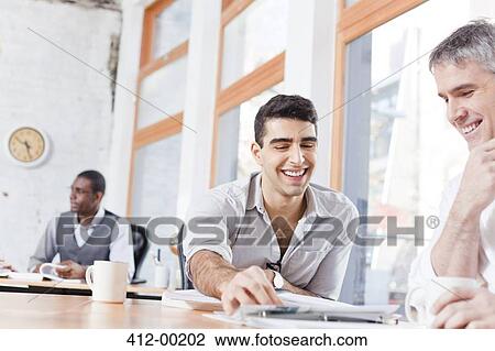 Businessmen talking in office View Large Photo Image Stock Image - Businessmen talking in office. Fotosearch