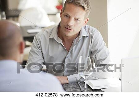 Businessmen talking in restaurant View Large Photo Image Stock Photo - Businessmen talking in restaurant. Fotosearch