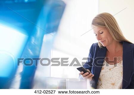 Businesswoman using cell phone View Large Photo Image Stock Photo - Businesswoman using cell phone. Fotosearch