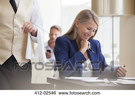 Businesswoman working in restaurant View Large Photo Image Stock Photograph - Businesswoman working in restaurant. Fotosearch