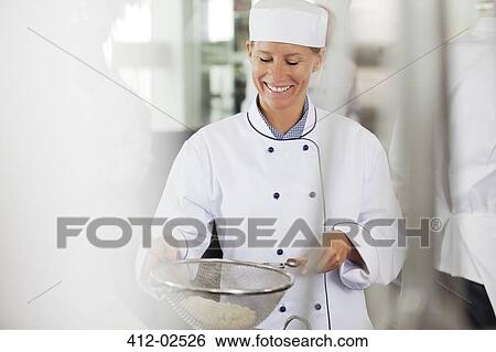 Stock Photograph - Chef baking in restaurant kitchen. Fotosearch