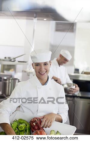 Chef carrying tub of vegetables in restaurant kitchen View Large Photo Image Stock Photography - Chef carrying tub of vegetables in restaurant kitchen. Fotosearch