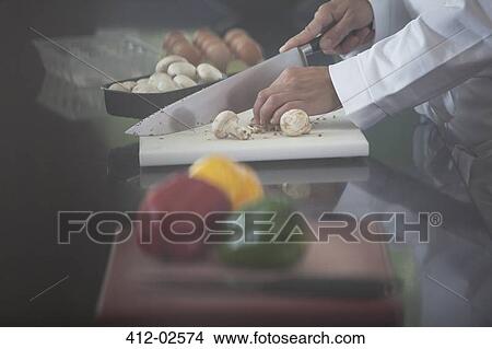Chef chopping vegetables in restaurant kitchen View Large Photo Image Picture - Chef chopping vegetables in restaurant kitchen. Fotosearch