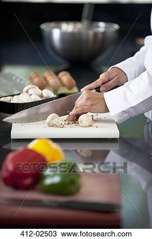 Chef chopping vegetables in restaurant kitchen View Large Photo Image Stock Image - Chef chopping vegetables in restaurant kitchen. Fotosearch