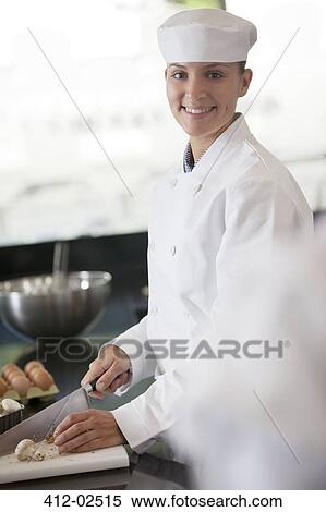 Chef chopping vegetables in restaurant kitchen View Large Photo Image Stock Photography - Chef chopping vegetables in restaurant kitchen. Fotosearch