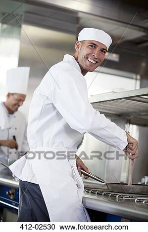 Chef cooking in restaurant kitchen View Large Photo Image Stock Image - Chef cooking in restaurant kitchen. Fotosearch
