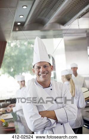 Picture - Chef smiling in restaurant kitchen. Fotosearch