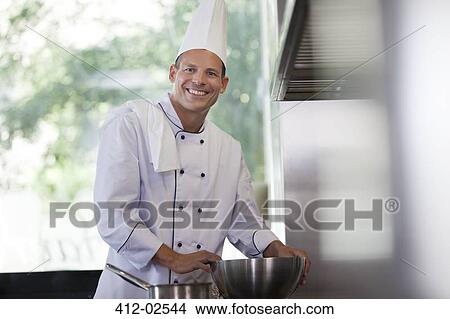 Chef smiling in restaurant kitchen View Large Photo Image Picture - Chef smiling in restaurant kitchen. Fotosearch