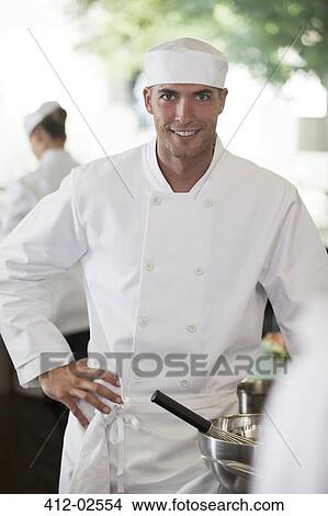Chef smiling in restaurant kitchen View Large Photo Image Picture - Chef smiling in restaurant kitchen. Fotosearch