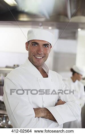 Picture - Chef smiling in restaurant kitchen. Fotosearch