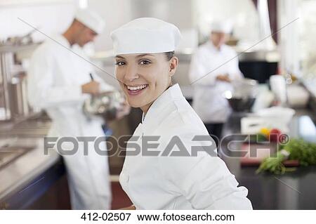 Chef smiling in restaurant kitchen View Large Photo Image Stock Photo - Chef smiling in restaurant kitchen. Fotosearch