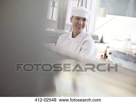 Stock Photo - Chef smiling in restaurant kitchen. Fotosearch