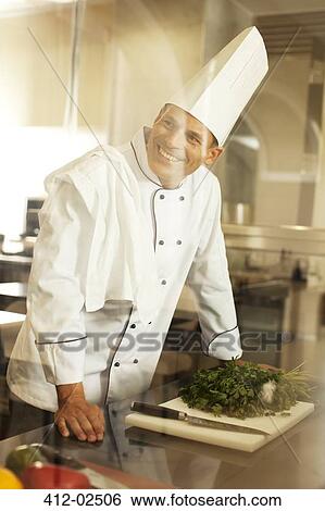 Chef smiling in restaurant kitchen View Large Photo Image Stock Photograph - Chef smiling in restaurant kitchen. Fotosearch