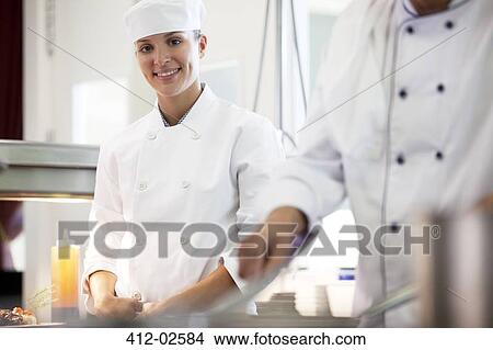 Chefs cooking in restaurant kitchen View Large Photo Image Picture - Chefs cooking in restaurant kitchen. Fotosearch