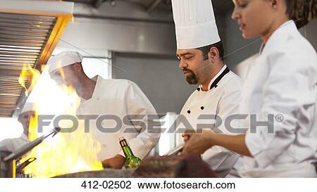 Chefs cooking in restaurant kitchen View Large Photo Image Stock Image - Chefs cooking in restaurant kitchen. Fotosearch