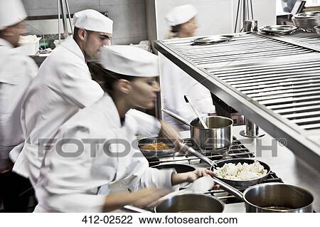 Chefs cooking in restaurant kitchen View Large Photo Image Stock Image - Chefs cooking in restaurant kitchen. Fotosearch