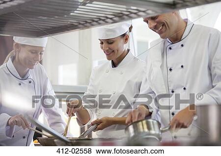 Chefs cooking in restaurant kitchen View Large Photo Image Stock Photo - Chefs cooking in restaurant kitchen. Fotosearch