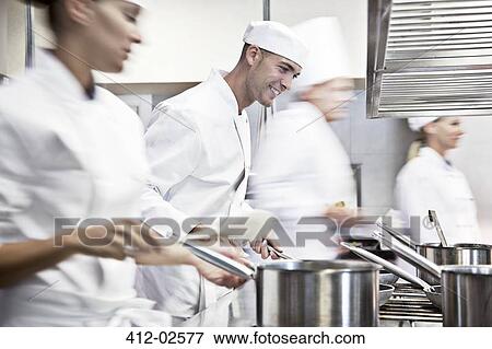 Chefs cooking in restaurant kitchen View Large Photo Image Stock Photo - Chefs cooking in restaurant kitchen. Fotosearch