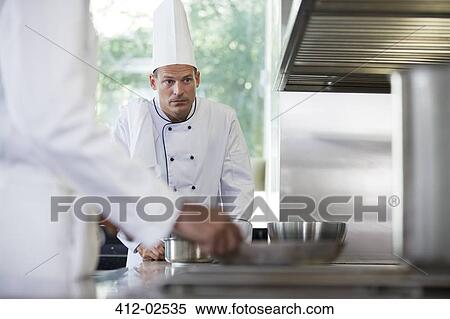 Chefs cooking in restaurant kitchen View Large Photo Image Stock Photography - Chefs cooking in restaurant kitchen. Fotosearch
