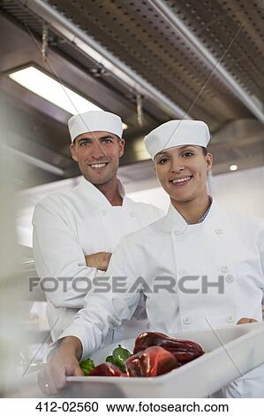 Chefs smiling in restaurant kitchen View Large Photo Image Stock Image - Chefs smiling in restaurant kitchen. Fotosearch