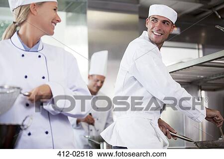 Stock Photo - Chefs talking in restaurant kitchen. Fotosearch