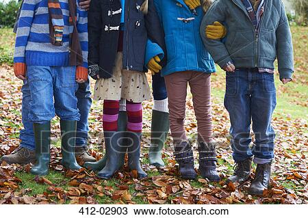 Children standing together in autumn leaves View Large Photo Image Stock Image - Children standing together in autumn leaves. Fotosearch