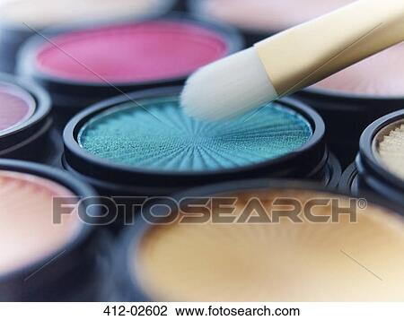 Stock Image - Close up of makeup brush with eyeshadows. Fotosearch