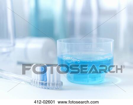 Stock Image - Close up of toothbrush and mouthwash. Fotosearch