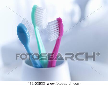 Stock Image - Close up of toothbrushes in holder. Fotosearch
