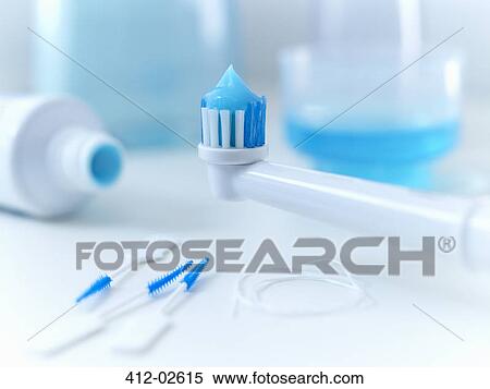 Stock Photography - Close up of toothpaste on electric toothbrush. Fotosearch