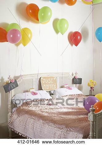 Colorful balloons over marriage bed View Large Photo Image Stock Photograph - Colorful balloons over marriage bed. Fotosearch