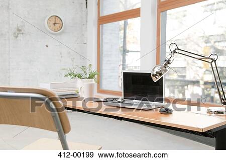 Laptop on desk in office View Large Photo Image Stock Photo - Laptop on desk in office. Fotosearch