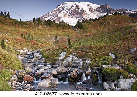 Stock Photo - Mountain overlooking rocky creek and rural landscape. Fotosearch