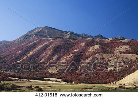 Stock Photo - Mountain overlooking rural landscape. Fotosearch