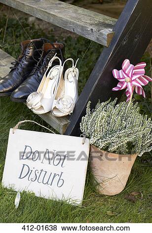 Newlywed couple's shoes with 'do not disturb' sign View Large Photo Image Stock Photo - Newlywed couple's shoes with 'do not disturb' sign. Fotosearch