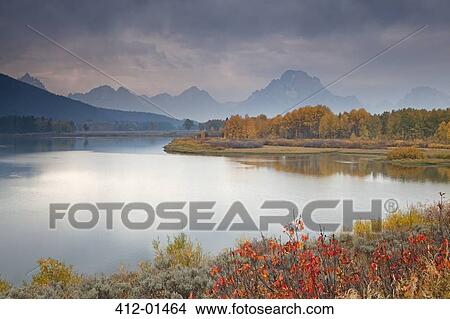 Rural landscape reflected in still river View Large Photo Image Picture - Rural landscape reflected in still river. Fotosearch