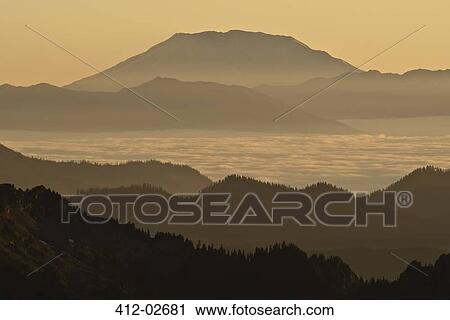Silhouette of mountain over foggy landscape View Large Photo Image Stock Image - Silhouette of mountain over foggy landscape. Fotosearch