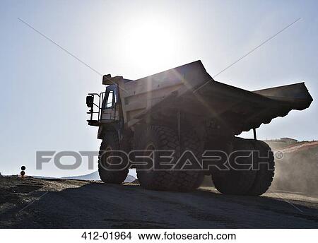 Picture - Silhouette of truck in quarry. Fotosearch